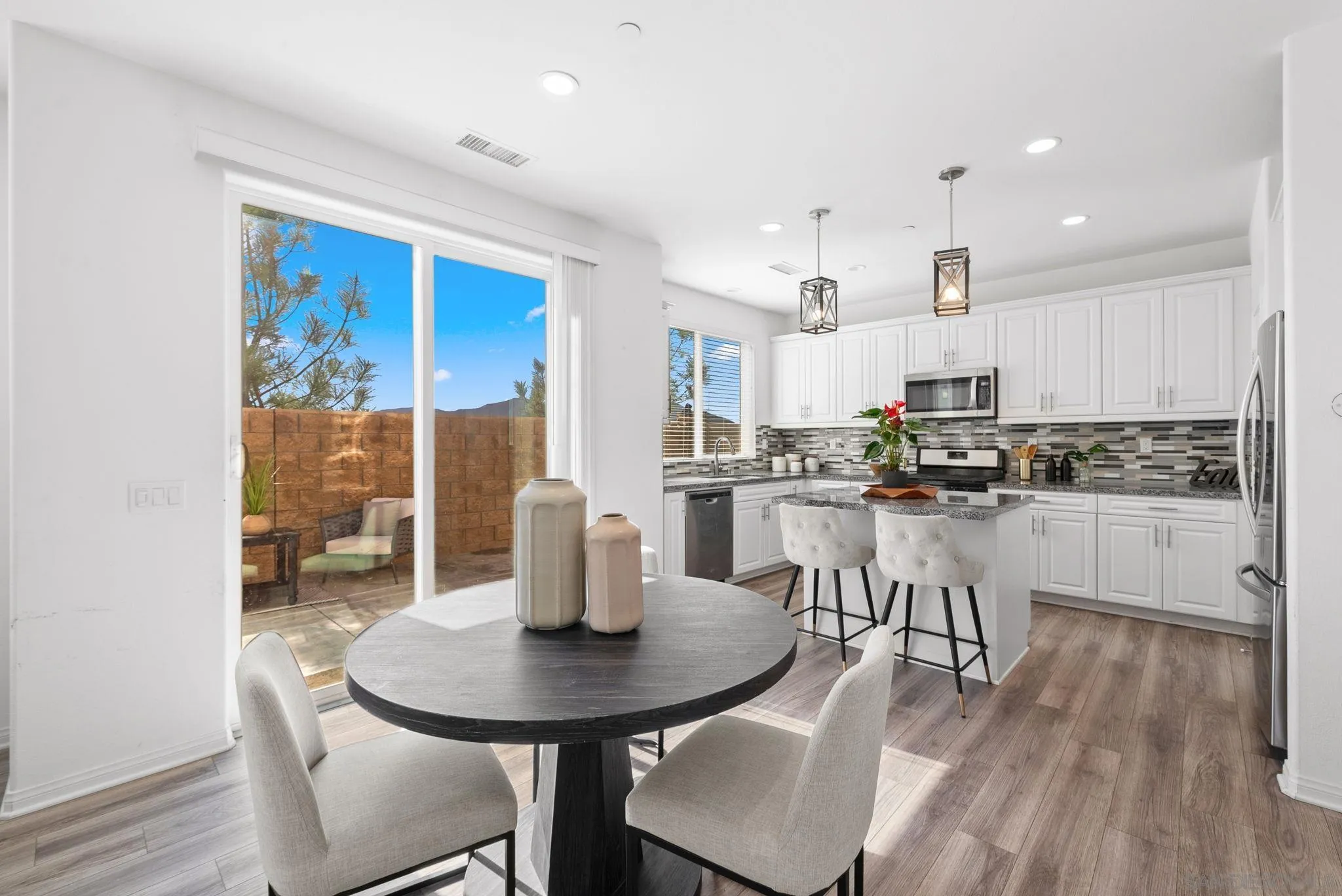 8749 Scrub Oak Street Santee, CA 92071 - Photo 3 of 43 a kitchen with white cabinets a sink and appliances