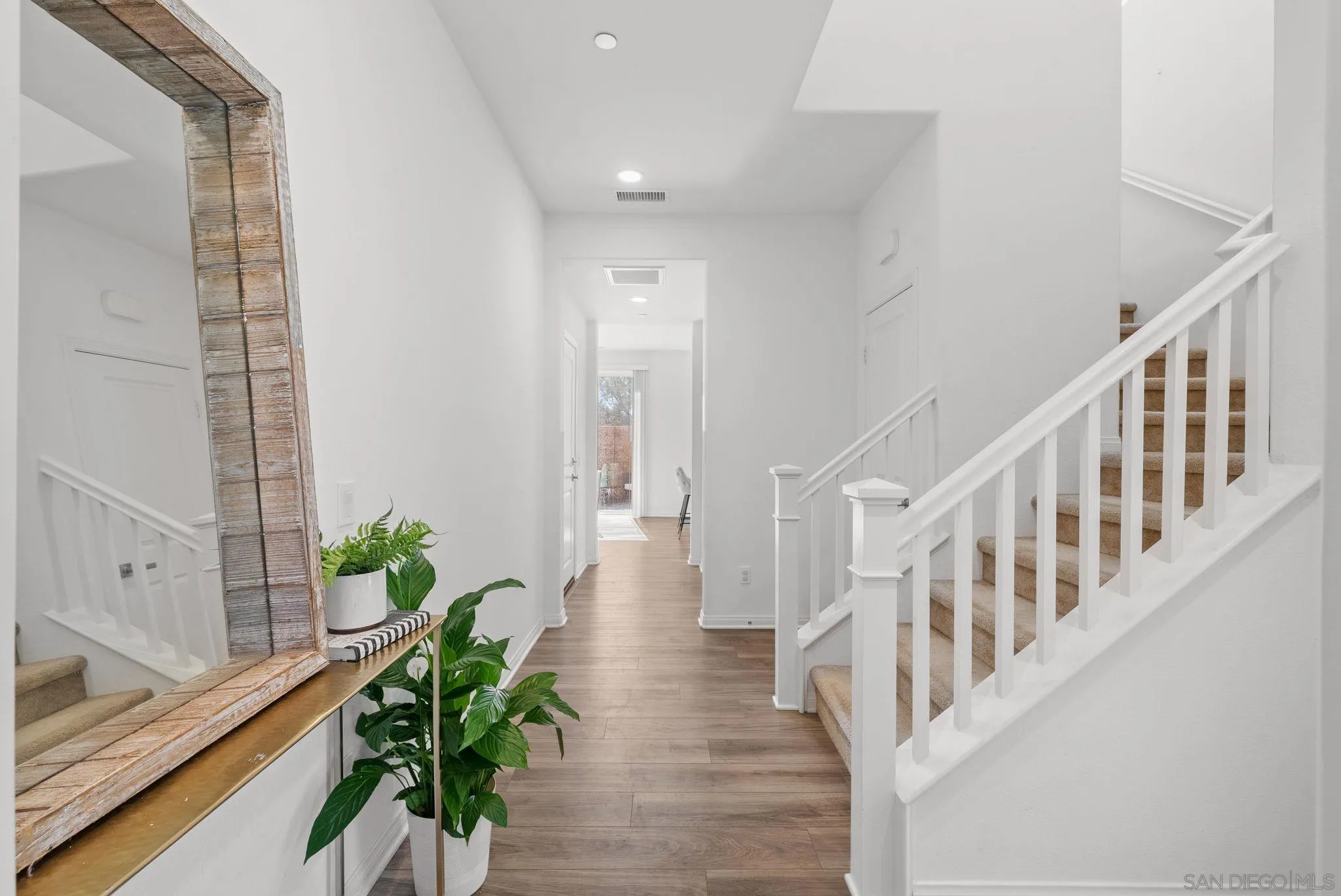 8749 Scrub Oak Street Santee, CA 92071 - Photo 6 of 43 a view of an entryway with wooden floor and a potted plant