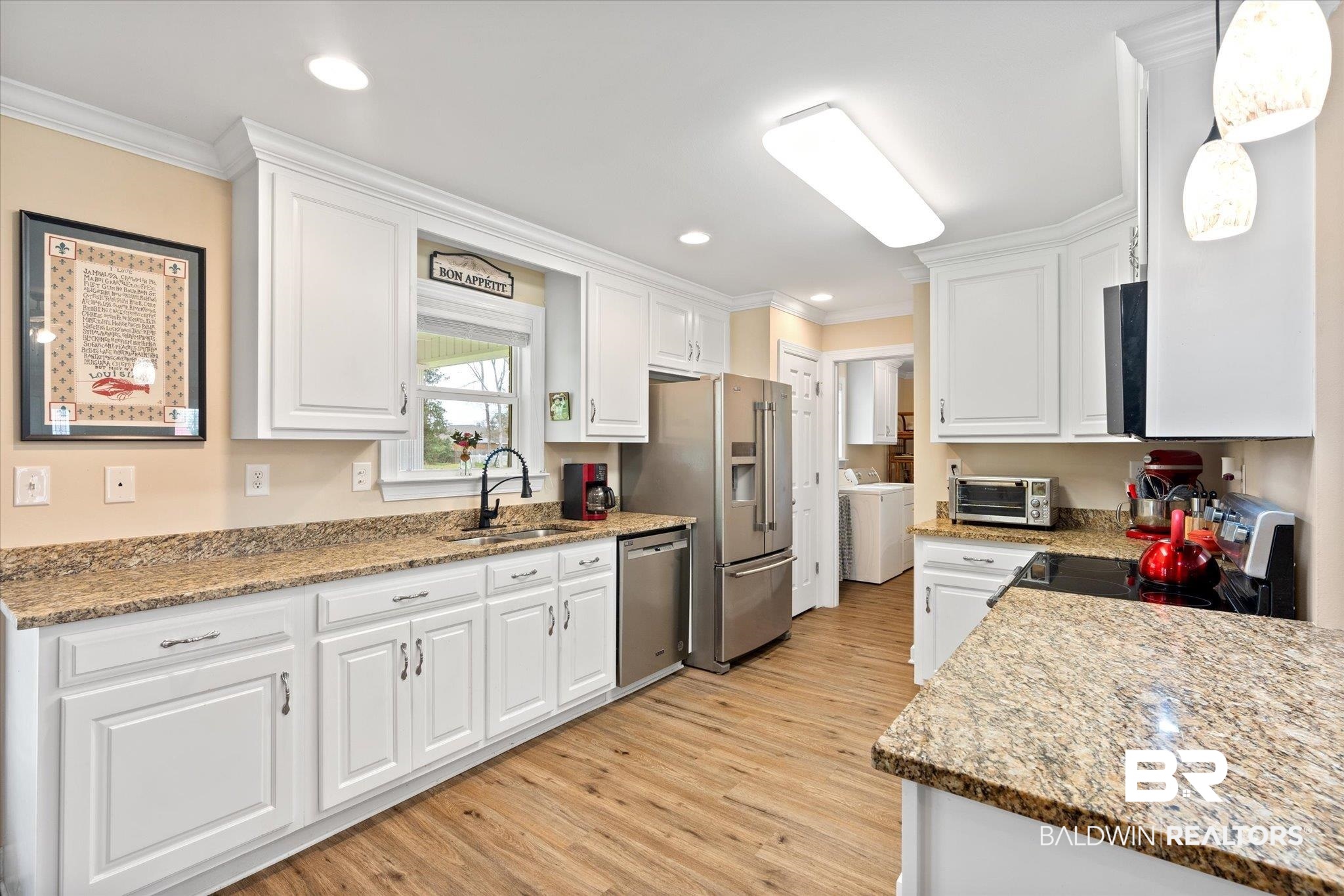734 West Section Avenue Foley, AL 36535 - Photo 11 of 50 Kitchen featuring a sink, stainless steel appliances, ornamental molding, and white cabinets