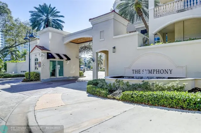 a front view of a house with garage and plants