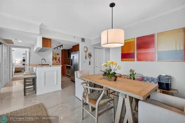a kitchen with stainless steel appliances granite countertop a sink and a refrigerator