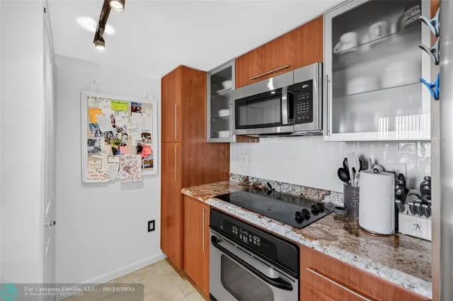 a kitchen with granite countertop a sink and stove