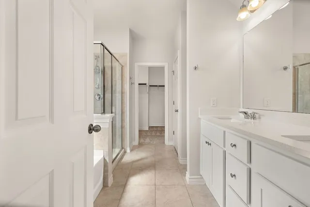a bathroom with a double vanity sink and mirror