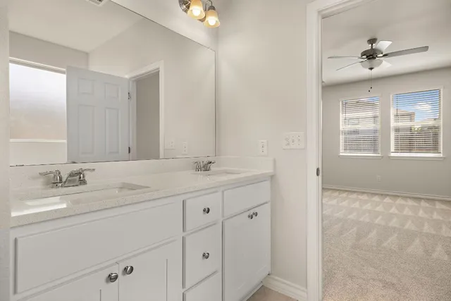 a bathroom with 2 sink tub and a mirror