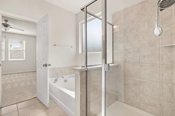 a bathroom with a bathtub and a shower