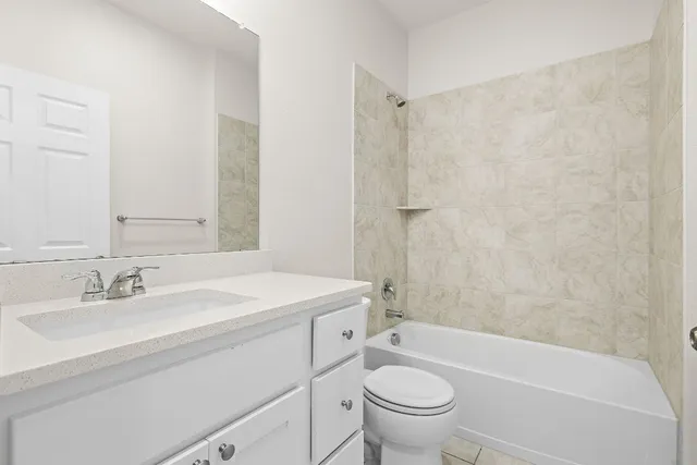 an empty room with a window and a ceiling fan