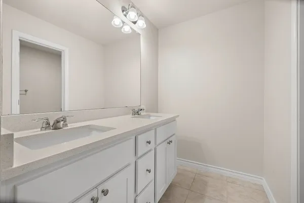 a bathroom with a double vanity sink and a mirror