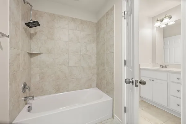 a bathroom with a bathtub a shower a vanity and a shower