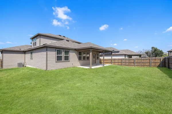 a view of a house with a backyard