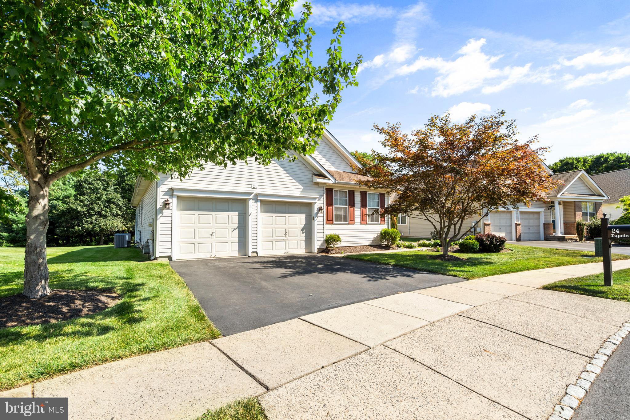 24 Tupelo Lane Langhorne, PA 19047 - Photo 1 of 37 a front view of a house with a yard and trees