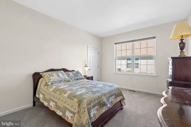 a bedroom with a bed chair and window