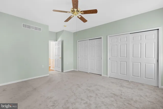 a spacious bathroom with a granite countertop sink toilet and shower