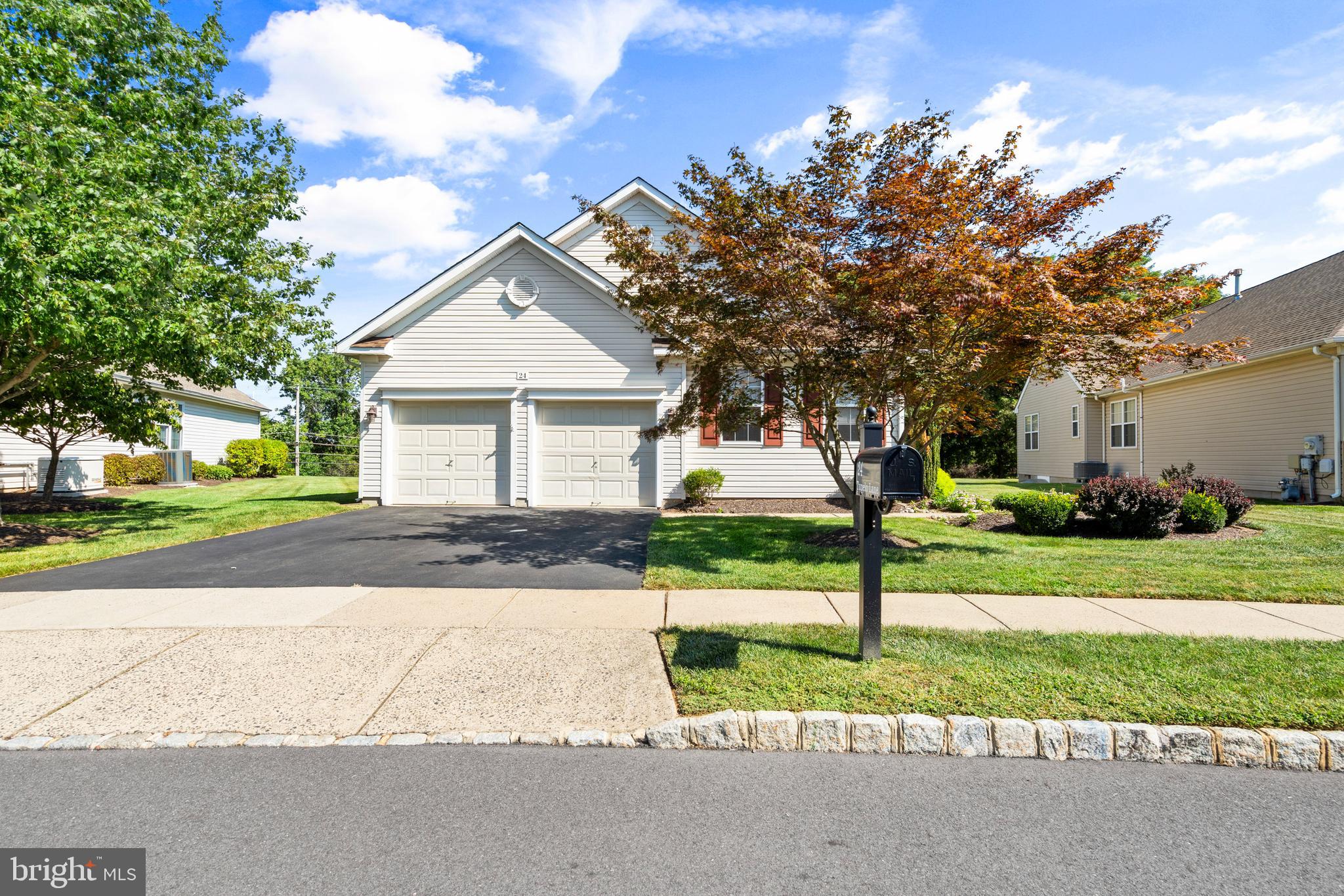 24 Tupelo Lane Langhorne, PA 19047 - Photo 2 of 37 a front view of a house with a yard and garage