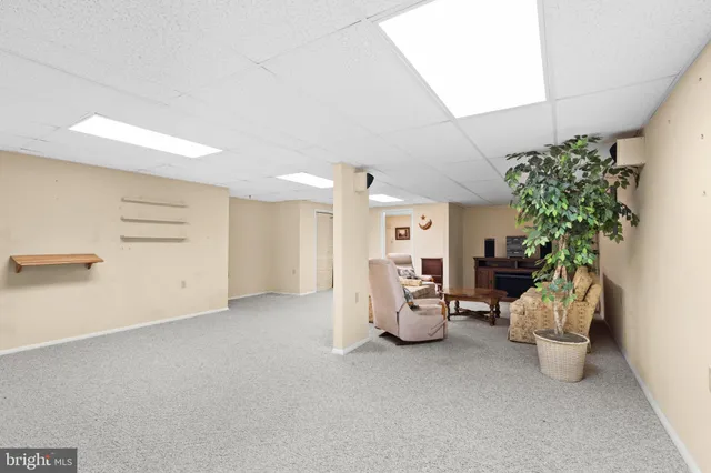 an aerial view of a house with a garden and mountain view in back