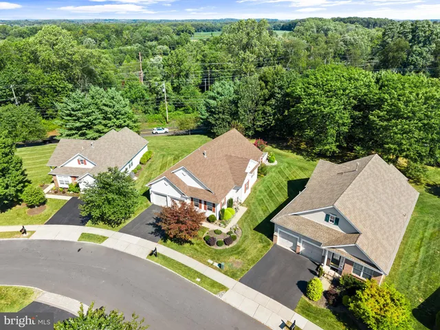 an aerial view of a house with a yard and greenery