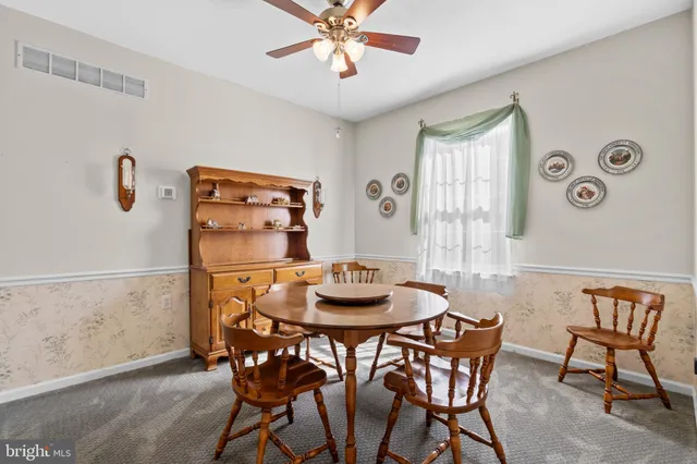 a view of a dining room with furniture and a chandelier