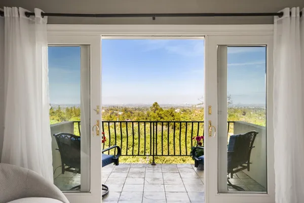 a view of a balcony with wooden floor
