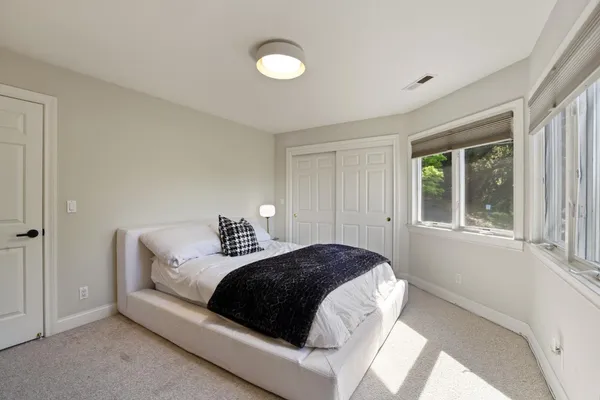 a bedroom with a bed and window