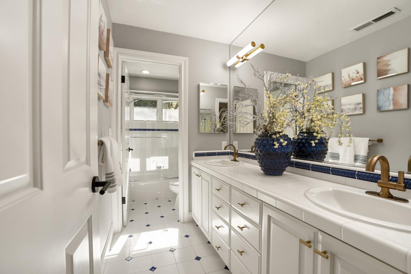 18782 Withey Road Monte Sereno, CA 95030 - Photo 25 of 39 a bathroom with a sink a potted plant and a glass door shower