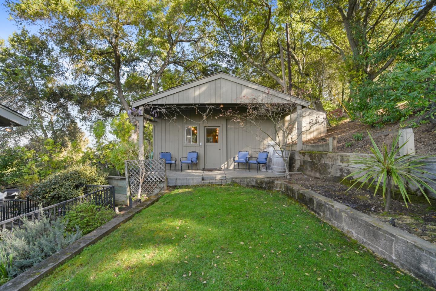 18782 Withey Road Monte Sereno, CA 95030 - Photo 29 of 39 a view of a patio with table and chairs under an umbrella