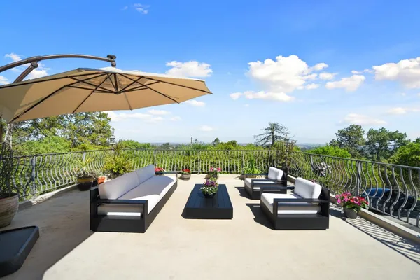 a view of a terrace with couches and pool