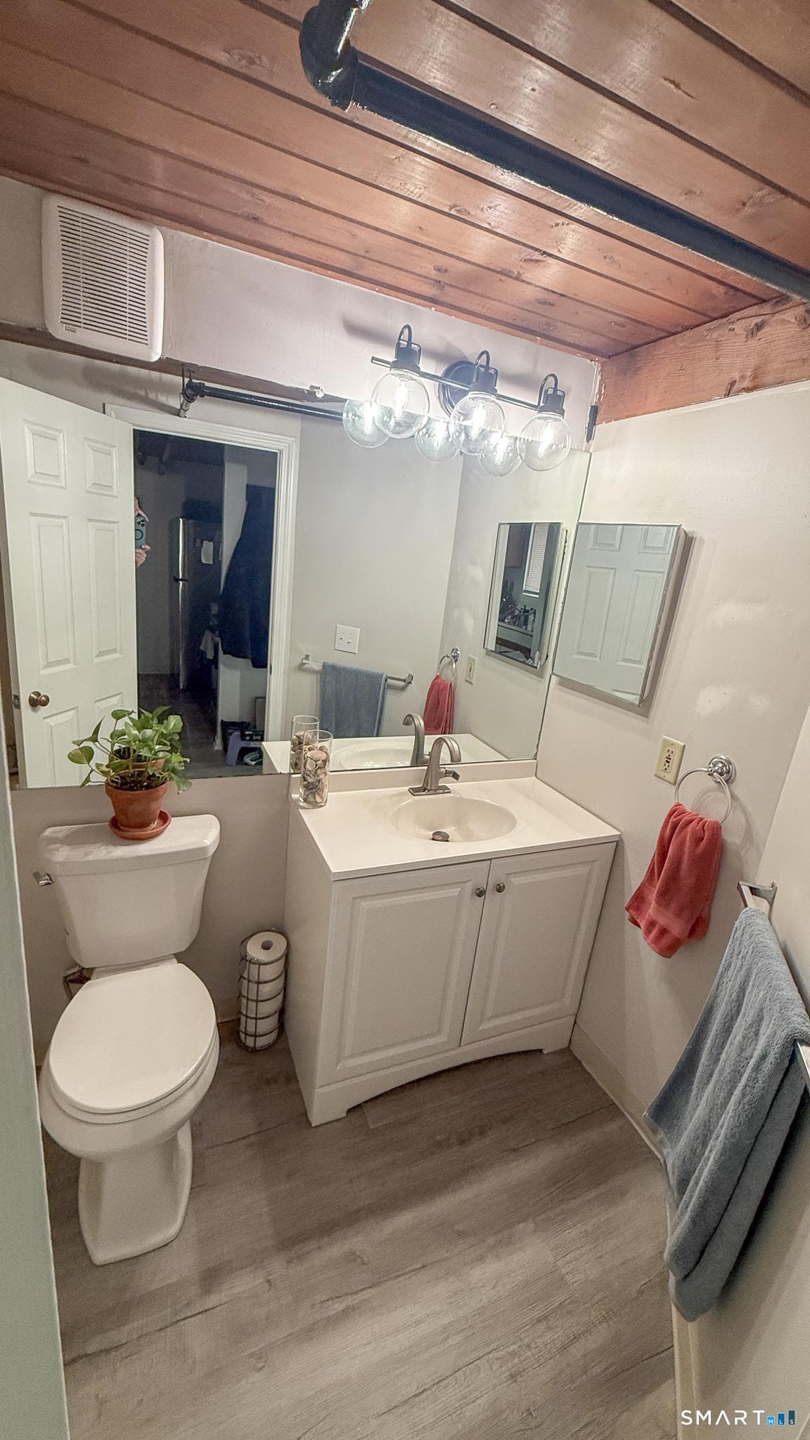 839 Main Street, Unit 68 Torrington, CT 06790 - Photo 8 of 20 a bathroom with a sink and mirror with toilet