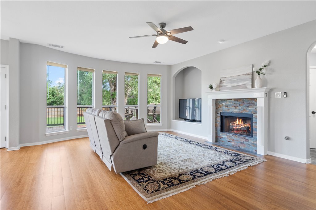 10801 Beachmont Lane Austin, TX 78739 - Photo 13 of 40 Cozy up to your stylish fireplace accented by beautiful grey stonework and stylish mantle. You'll love all the natural light that flows in from the windows!