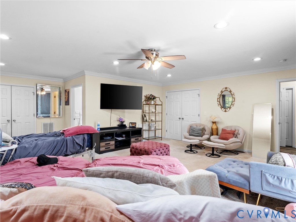 1920 Meadow Road Sandston, VA 23150 - Photo 25 of 46 a bedroom with furniture a flat screen tv and a chandelier