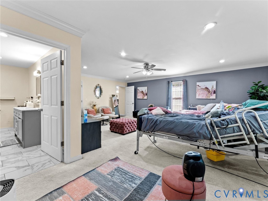 1920 Meadow Road Sandston, VA 23150 - Photo 26 of 46 a spacious bedroom with a bed a couch and dresser