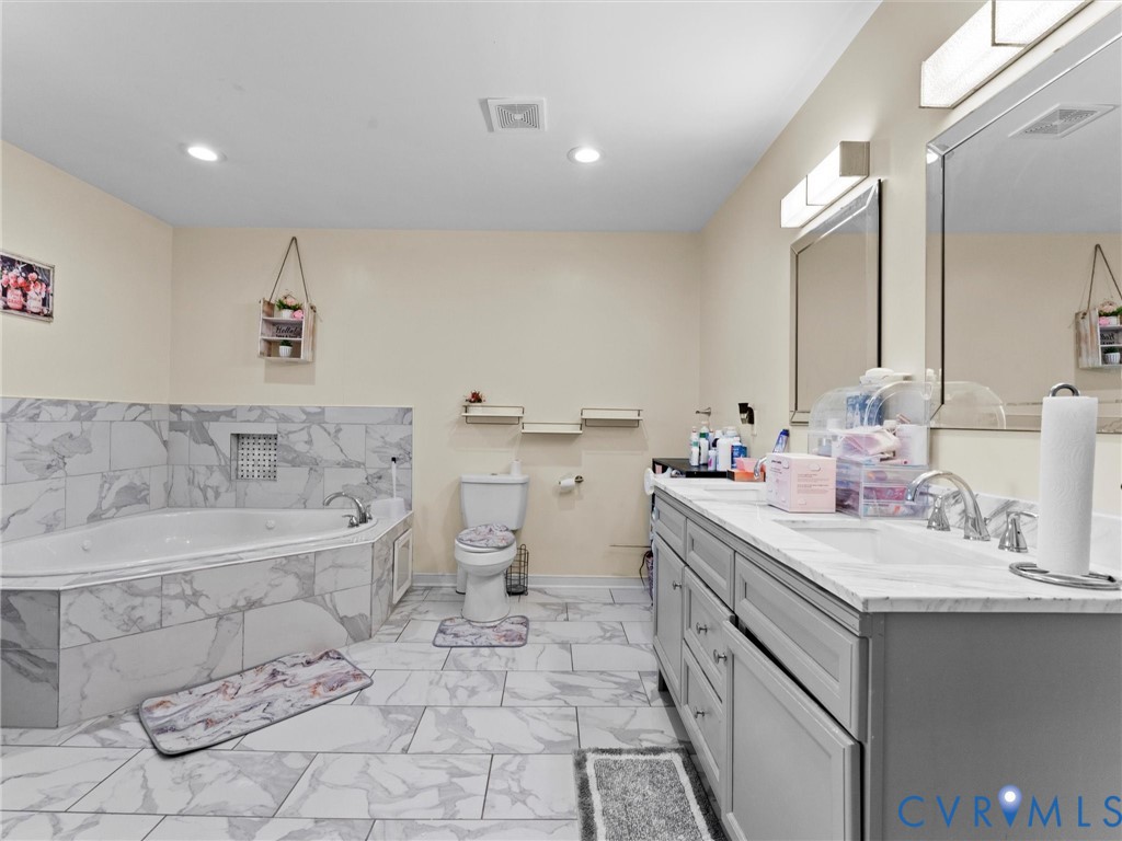 1920 Meadow Road Sandston, VA 23150 - Photo 27 of 46 a spacious bathroom with a bathtub sink mirror and toilet