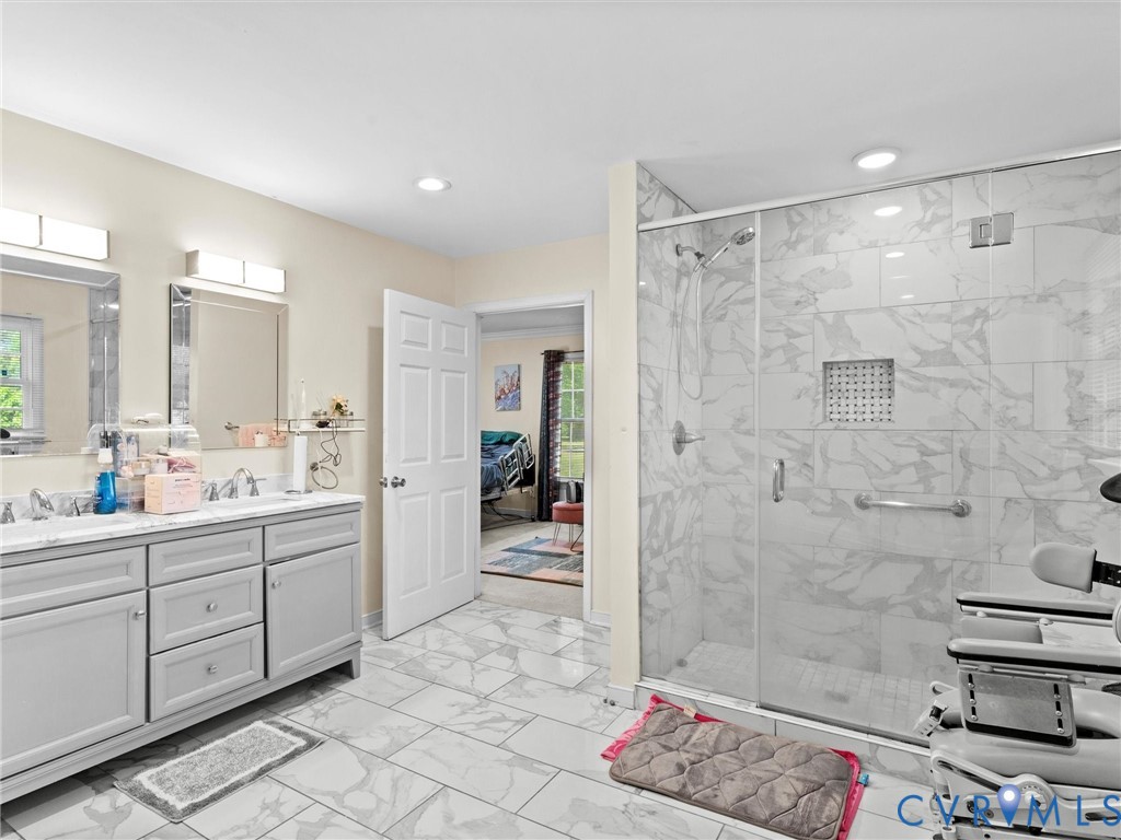 1920 Meadow Road Sandston, VA 23150 - Photo 31 of 46 a bathroom with a double vanity sink toilet and shower