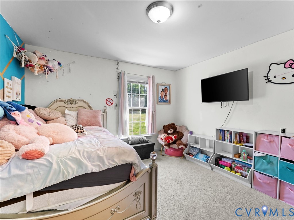 1920 Meadow Road Sandston, VA 23150 - Photo 37 of 46 a bedroom with a bed and a flat screen tv