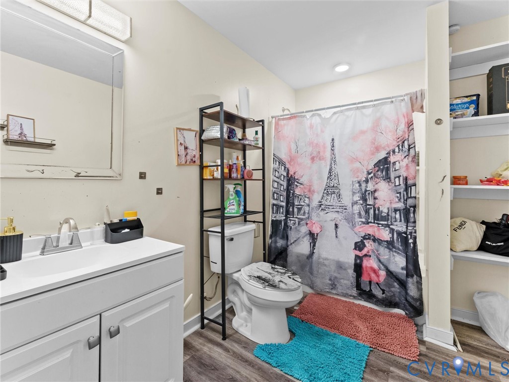1920 Meadow Road Sandston, VA 23150 - Photo 38 of 46 a bathroom with a toilet sink and shower curtain