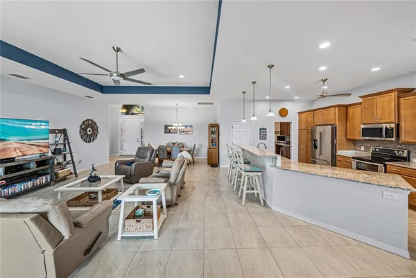 a large kitchen with granite countertop a sink and a refrigerator