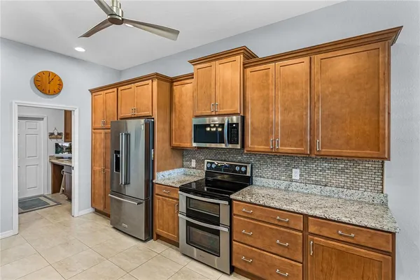 a spacious bathroom with a granite countertop sink mirror and cabinets