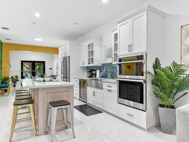 a bathroom with a granite countertop sink a toilet and shower