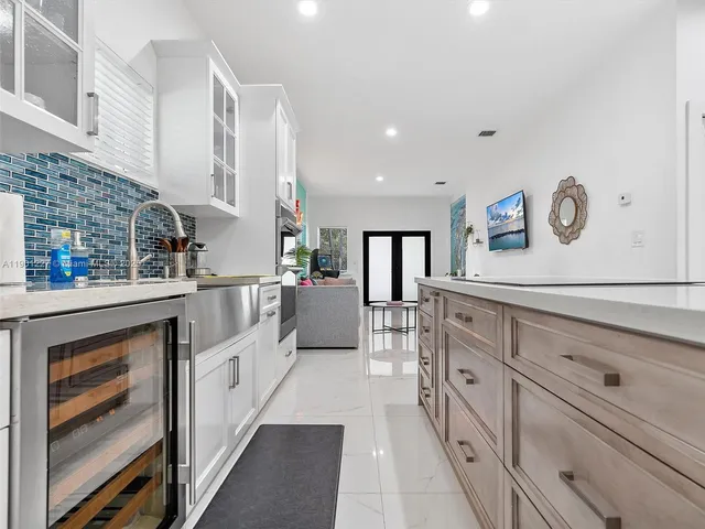 a kitchen with granite countertop a sink and a stove top oven