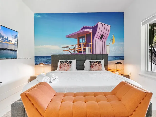 a bedroom with a bed and a chair