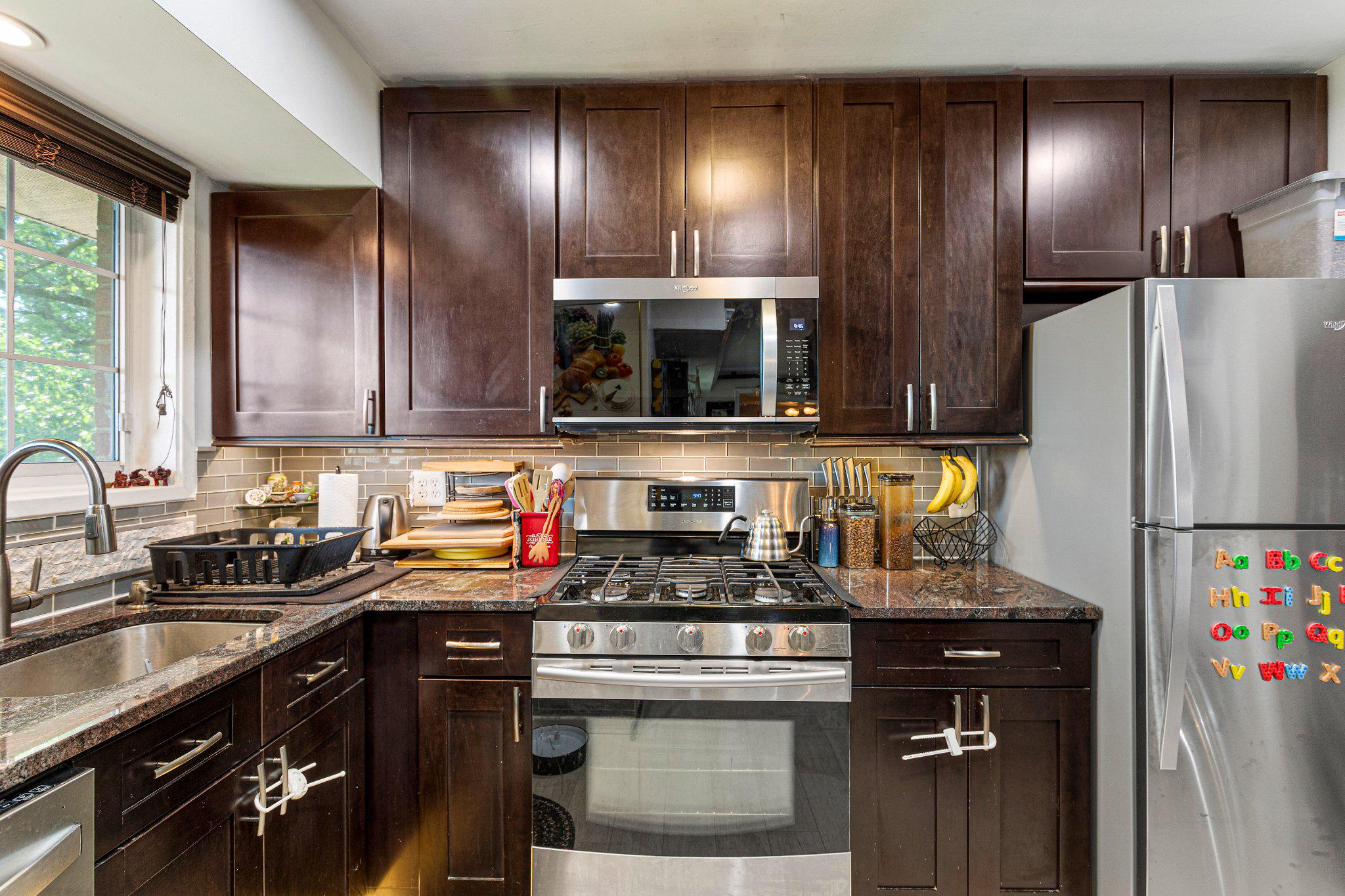 5613 Franconia Road, Unit 303 Alexandria, VA 22310 - Photo 11 of 27 a kitchen with stainless steel appliances granite countertop a refrigerator stove and sink