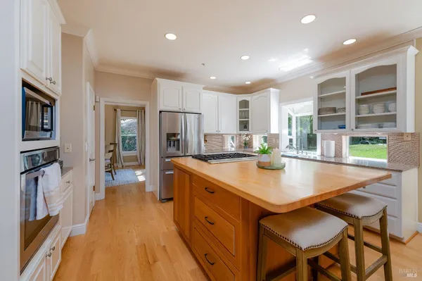 a kitchen with stainless steel appliances granite countertop counter space and a refrigerator