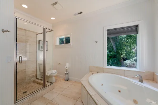 a bathroom with a bathtub and a shower