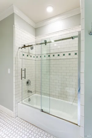 a bathroom with a bathtub and a shower