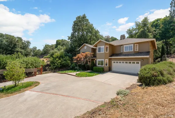 a front view of a house with a yard and garage