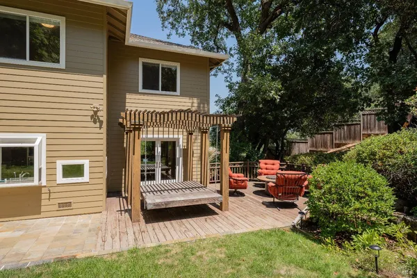 a view of backyard of house with seating space