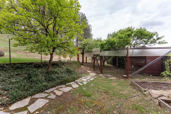 a view of a backyard with sitting area