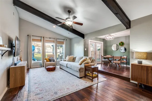 a living room with furniture and wooden floor