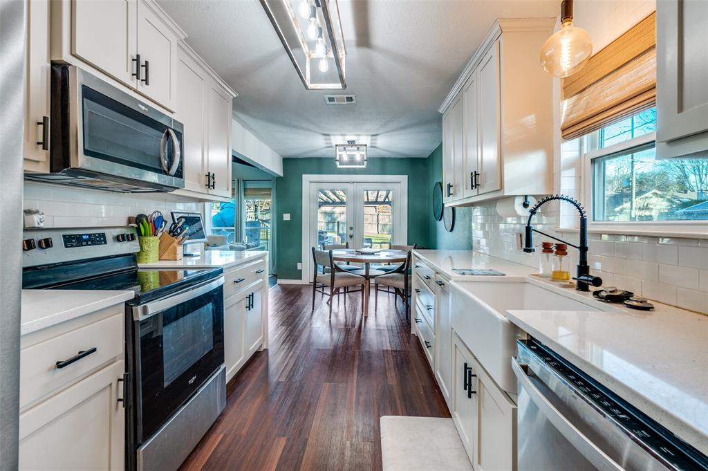 3700 Wedgworth Road South Fort Worth, TX 76133 - Photo 6 of 12 a kitchen with stainless steel appliances a stove sink microwave and cabinets
