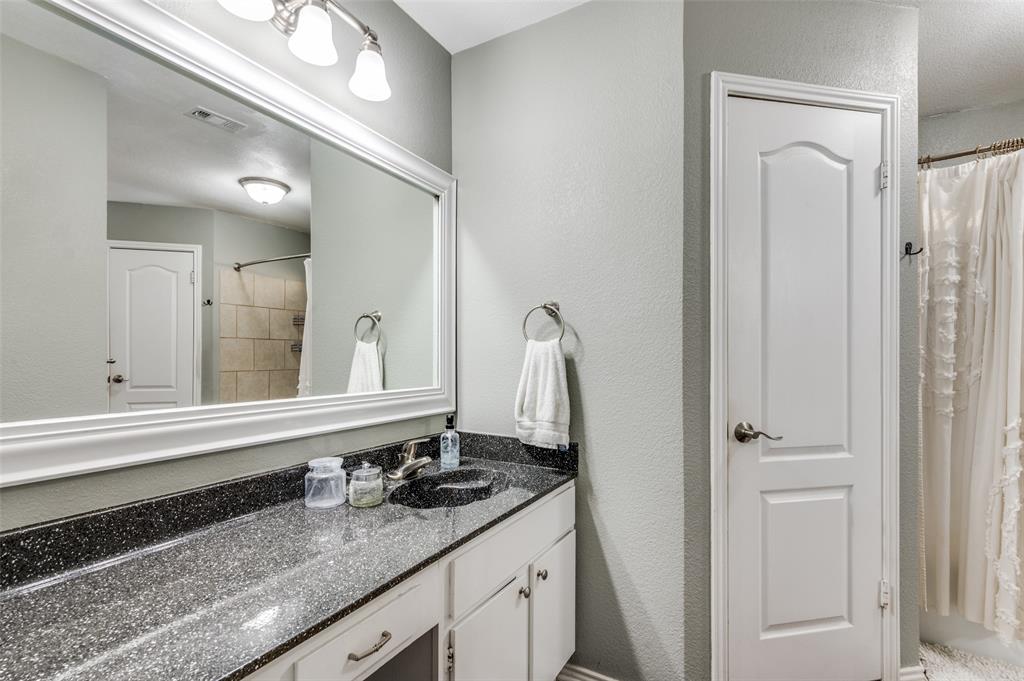 3700 Wedgworth Road South Fort Worth, TX 76133 - Photo 8 of 12 a bathroom with a granite countertop sink and a mirror