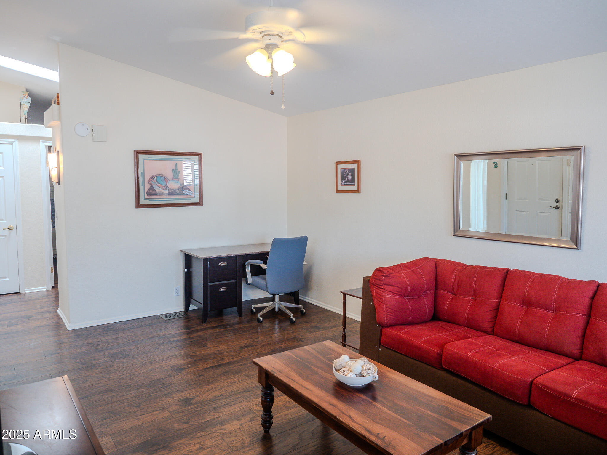 8865 East Baseline Road, Unit 1207 Mesa, AZ 85209 - Photo 12 of 40 a living room with furniture a couch and a bookshelf