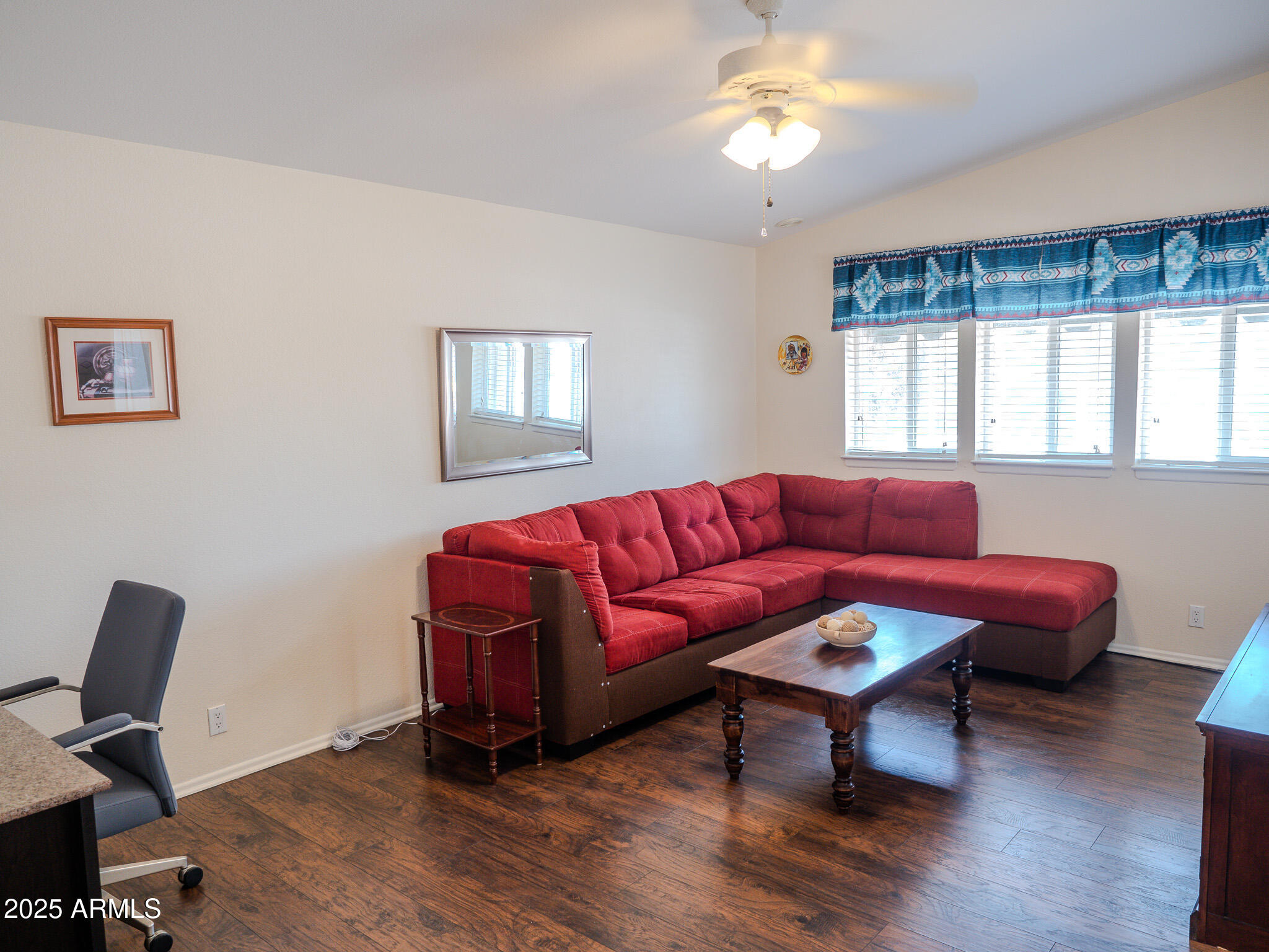 8865 East Baseline Road, Unit 1207 Mesa, AZ 85209 - Photo 13 of 40 a living room with furniture a window and a chandelier